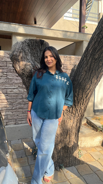 Model in teal Flamingo Line Shirt with quirky flamingo embroidery by Urrva