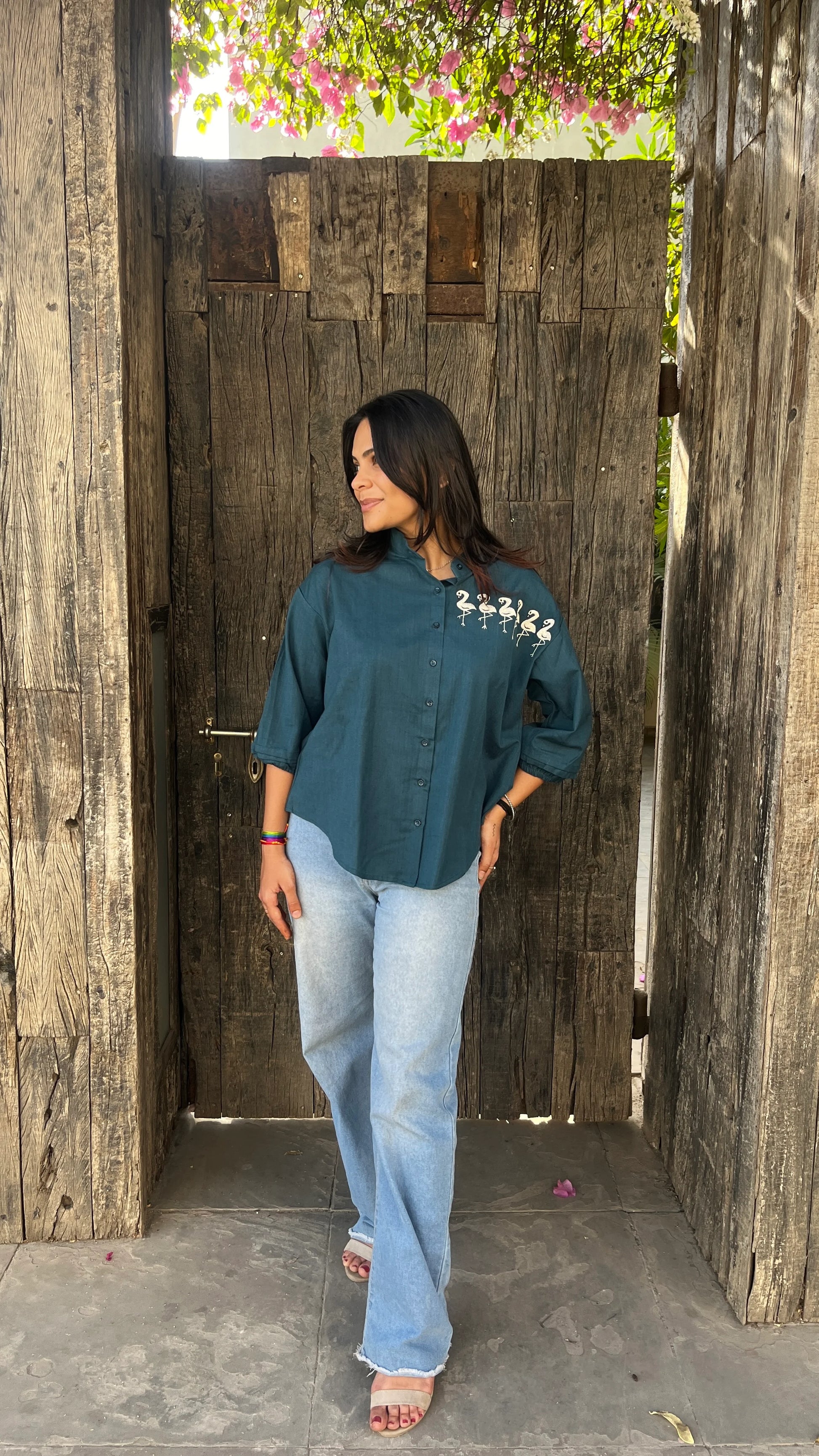 Model in teal Flamingo Line Shirt with quirky flamingo embroidery by Urrva