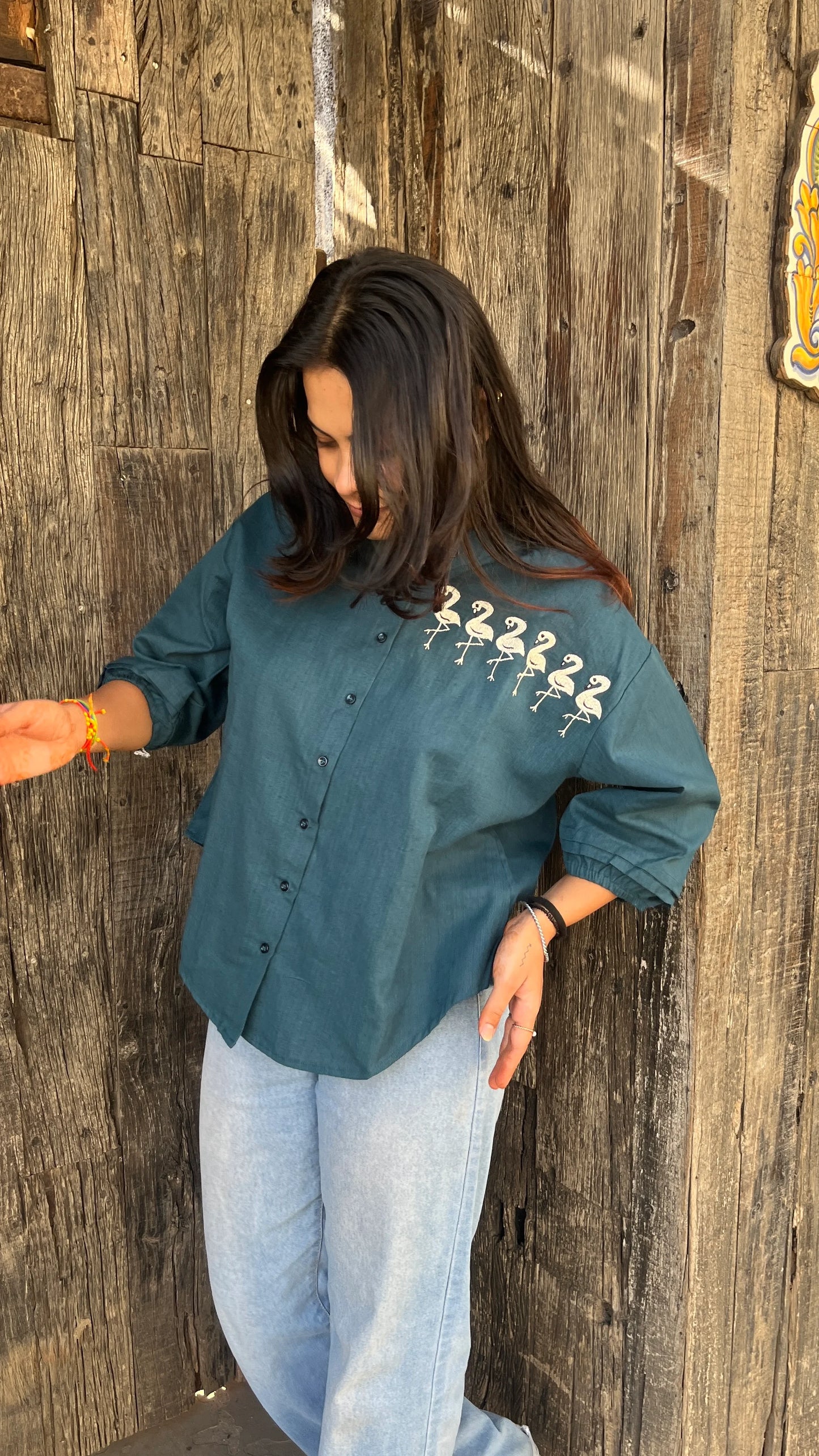 Model in teal Flamingo Line Shirt with quirky flamingo embroidery by Urrva