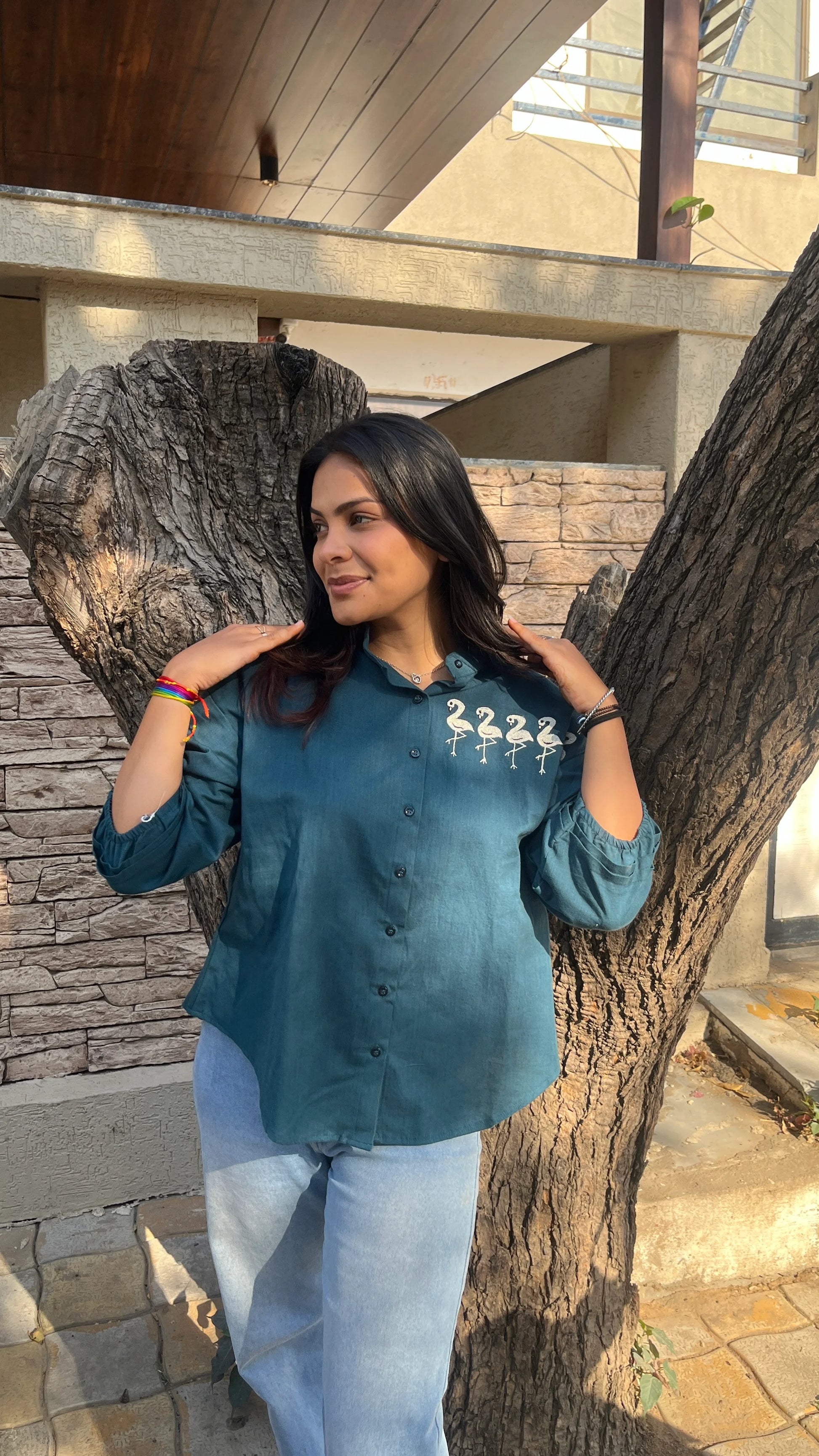 Model in teal Flamingo Line Shirt with quirky flamingo embroidery by Urrva