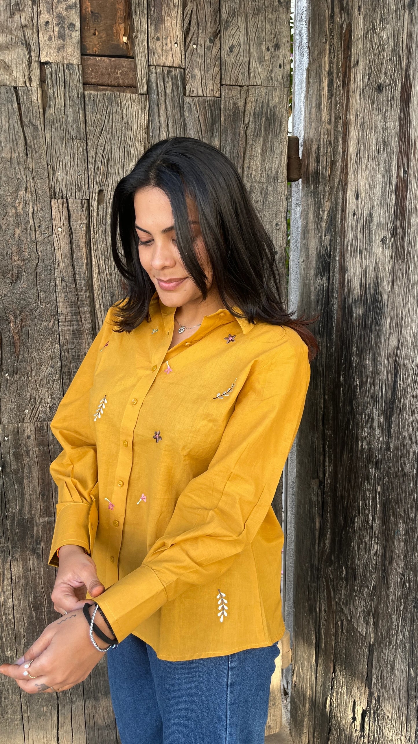 Model in mustard yellow Golden Bloom Shirt with floral embroidery by Urrva