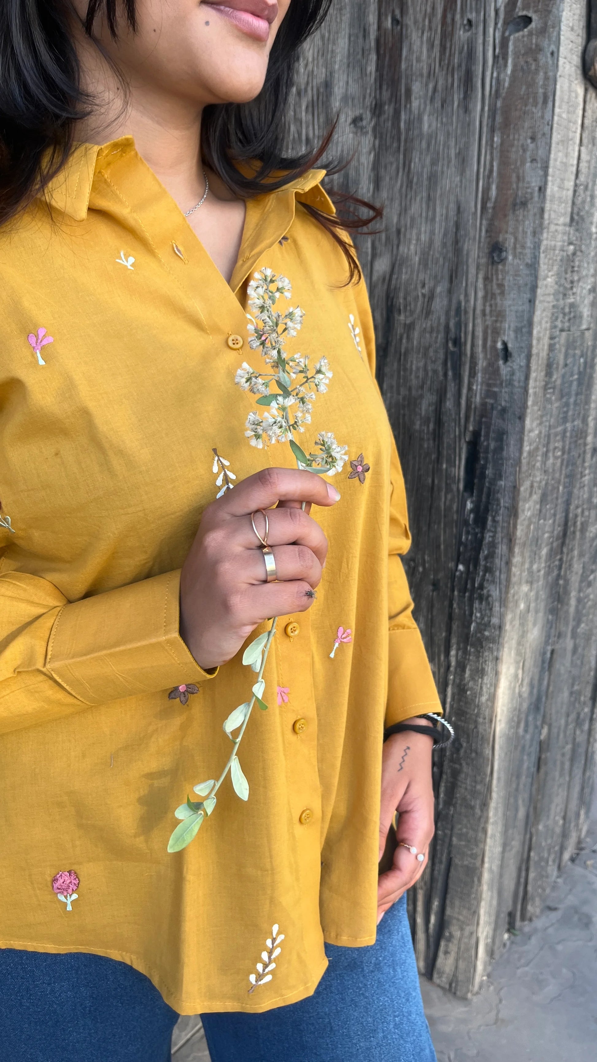 Model in mustard yellow Golden Bloom Shirt with floral embroidery by Urrva
