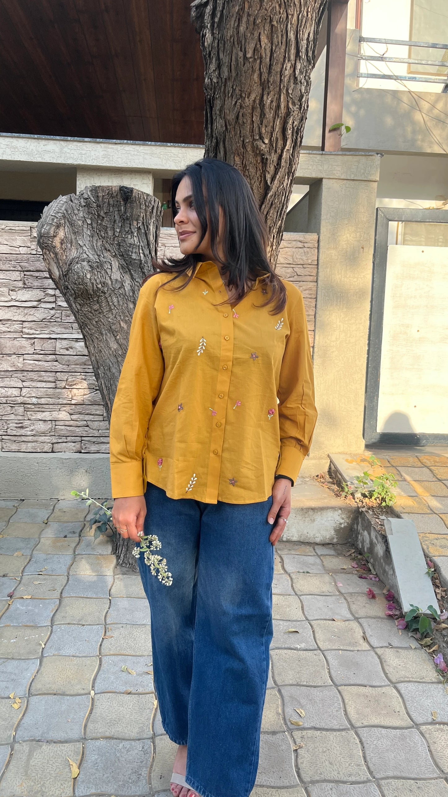 Model in mustard yellow Golden Bloom Shirt with floral embroidery by Urrva