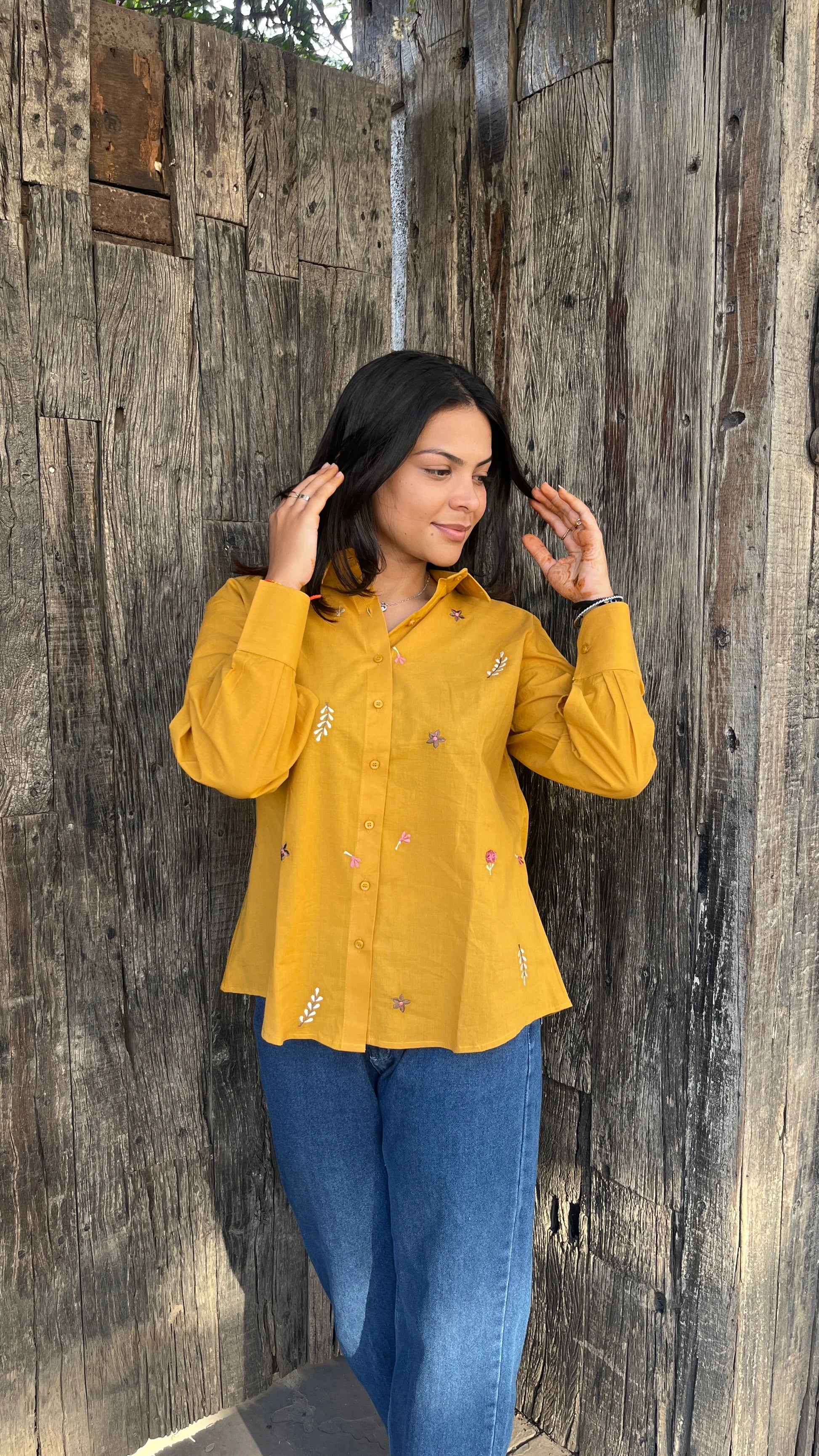 Model in mustard yellow Golden Bloom Shirt with floral embroidery by Urrva