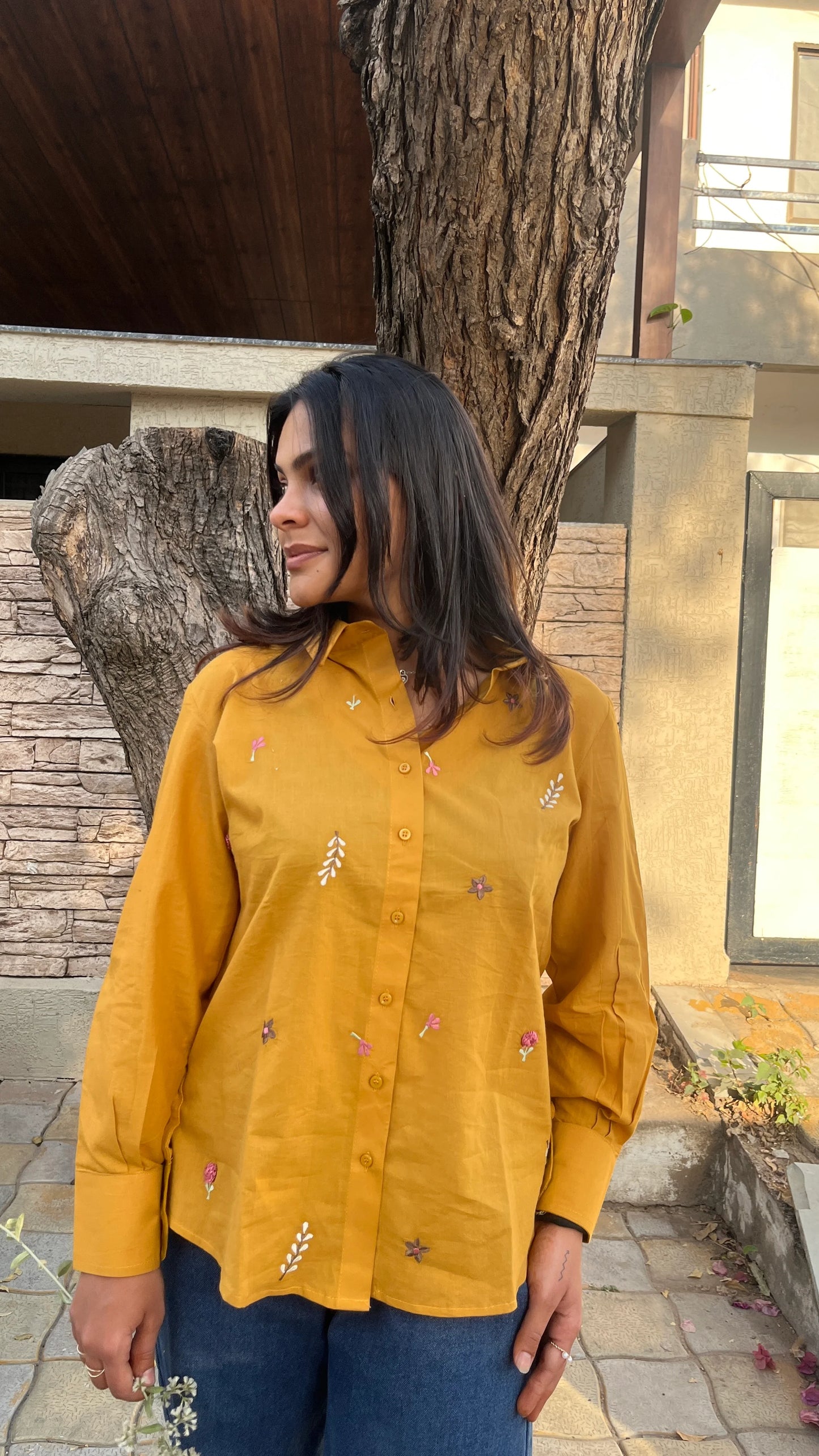 Model in mustard yellow Golden Bloom Shirt with floral embroidery by Urrva