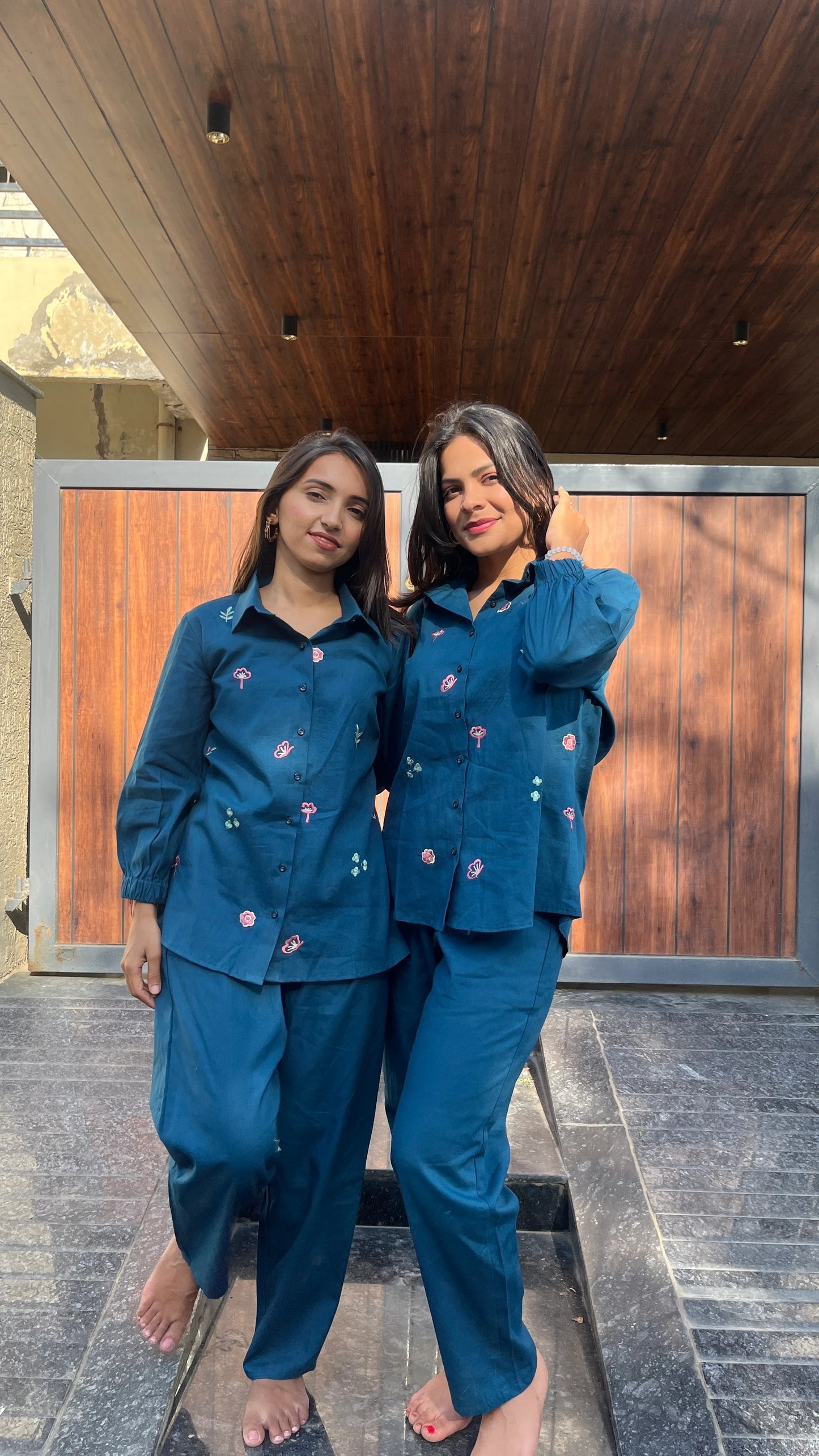 Two women wearing Urrva's Neelphool indigo co-ords with floral embroidery – cotton shirt and pants set