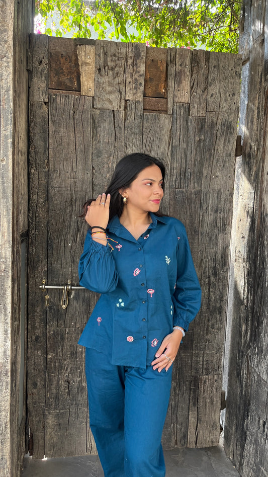 Two women wearing Urrva's Neelphool indigo co-ords with floral embroidery – cotton shirt and pants set