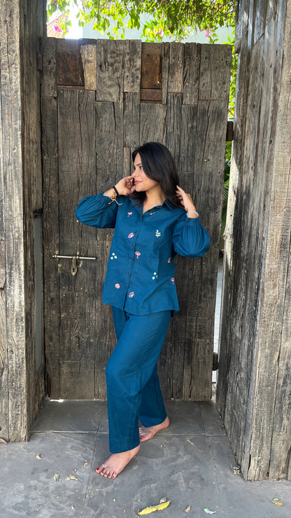 Two women wearing Urrva's Neelphool indigo co-ords with floral embroidery – cotton shirt and pants set