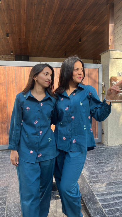 Two women wearing Urrva's Neelphool indigo co-ords with floral embroidery – cotton shirt and pants set