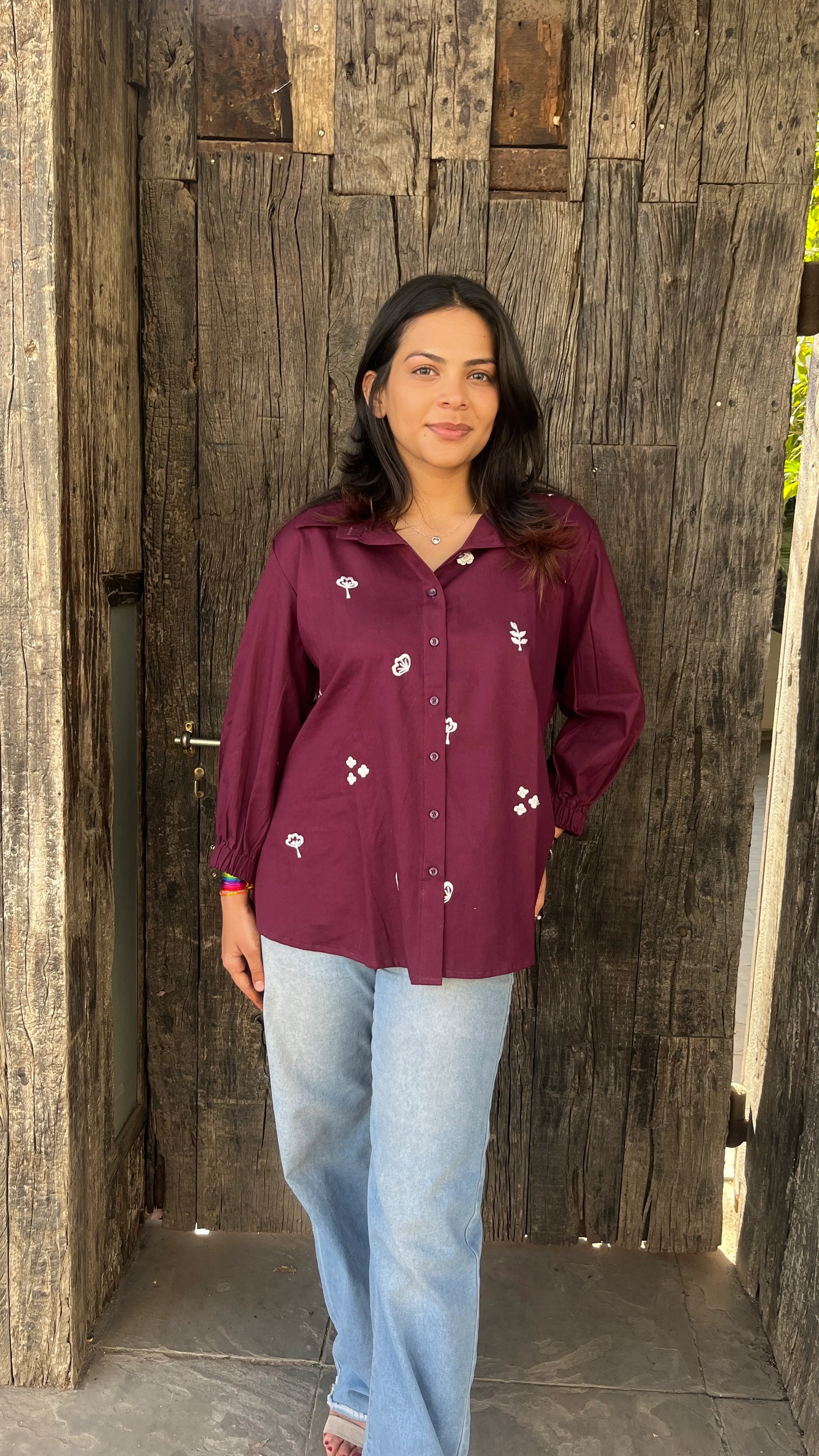 Model wearing wine bloom linen shirt with floral embroidery by Urrva