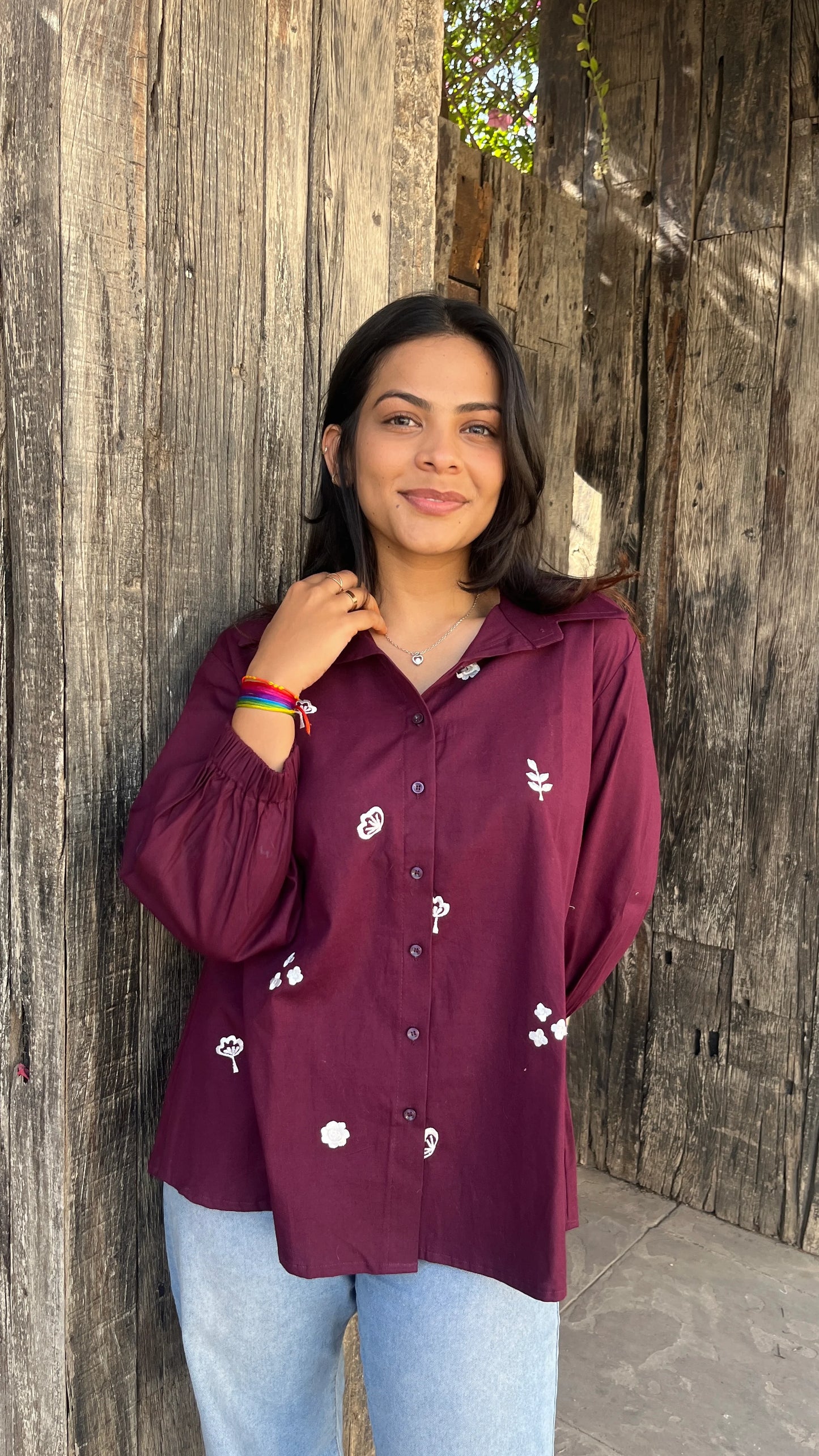 Model wearing wine bloom linen shirt with floral embroidery by Urrva