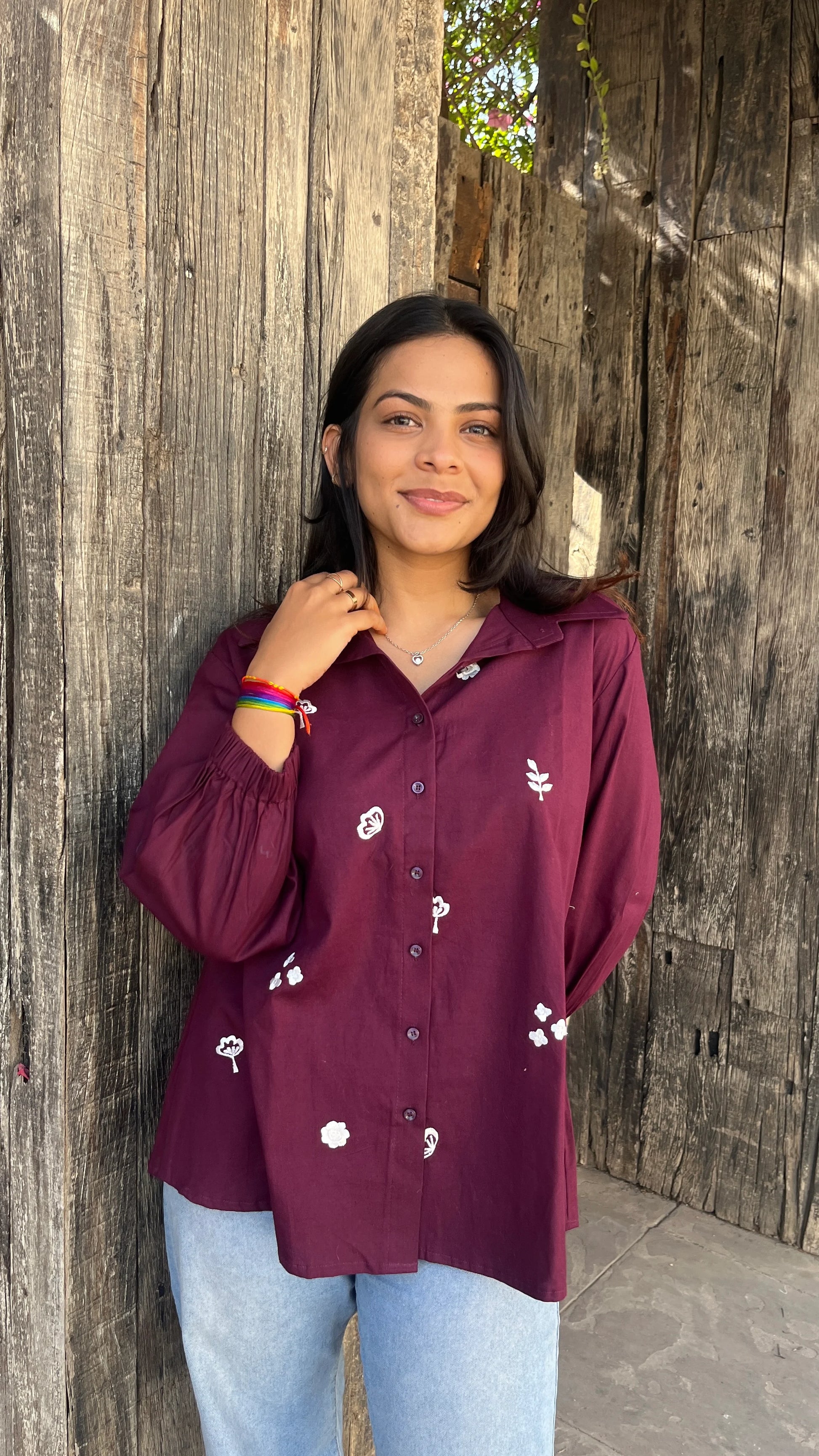 Model wearing wine bloom linen shirt with floral embroidery by Urrva