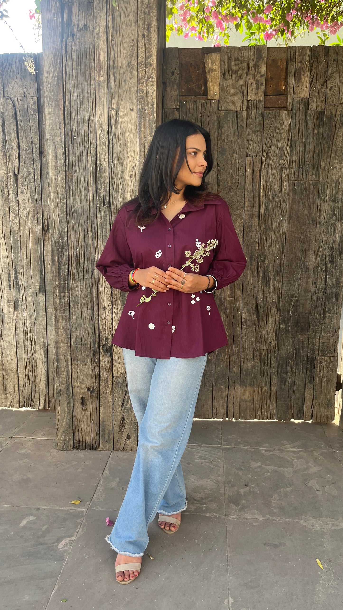 Model wearing wine bloom linen shirt with floral embroidery by Urrva